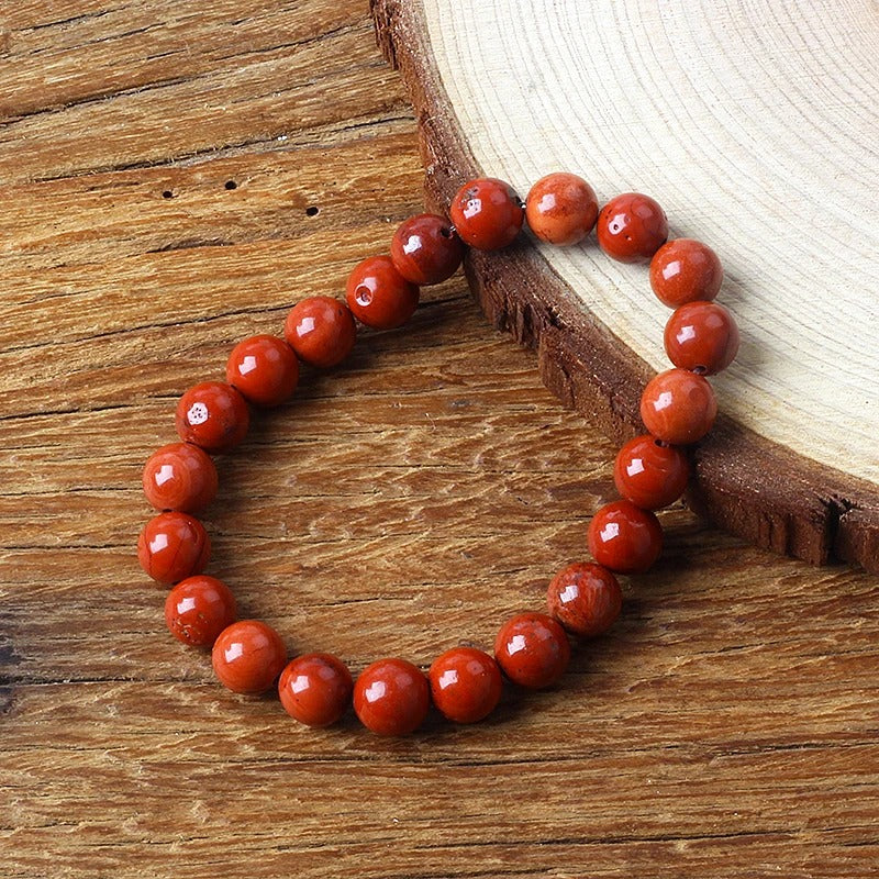 Bracelet Jaspe Rouge Pierres Rondes sur table en bois